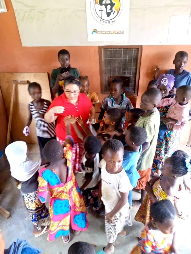 Una foto grupal de niños y voluntarios en un evento de Dorcas Foundation.