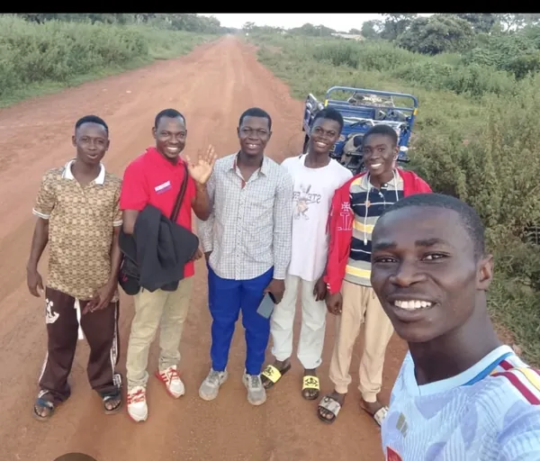 Voluntarios de Dorcas Foundation reunidos en un camino de tierra.